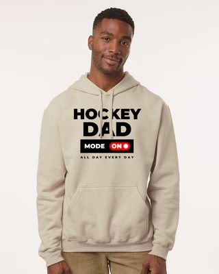Man wearing a beige hoodie with 'Hockey Dad Mode On All Day Every Day' text on a white background