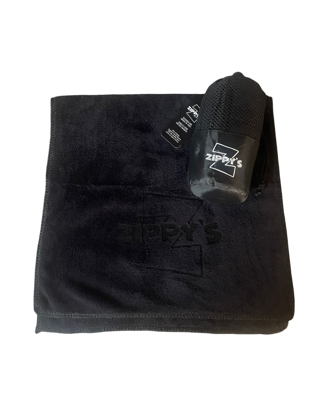 Black towel with a black spray bottle on a white background